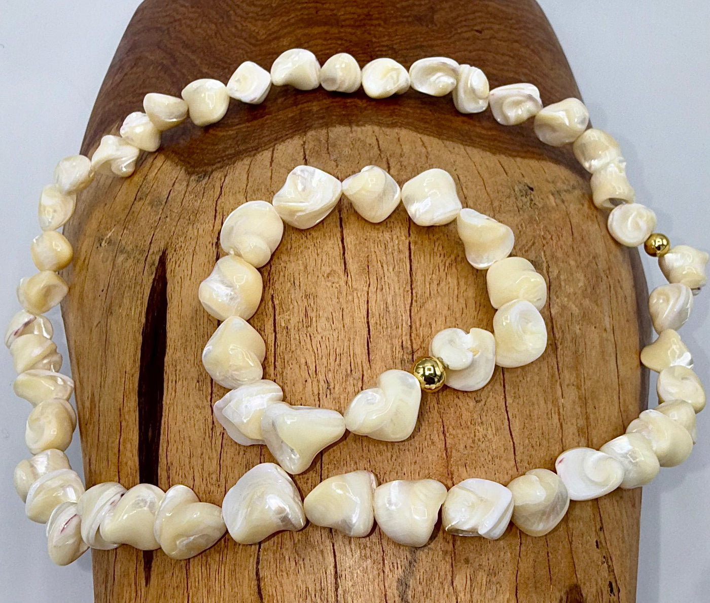 Square-shaped pearl necklace and bracelet jewelry set by STICS and STONES, featuring elegant pearl pieces on a white background.