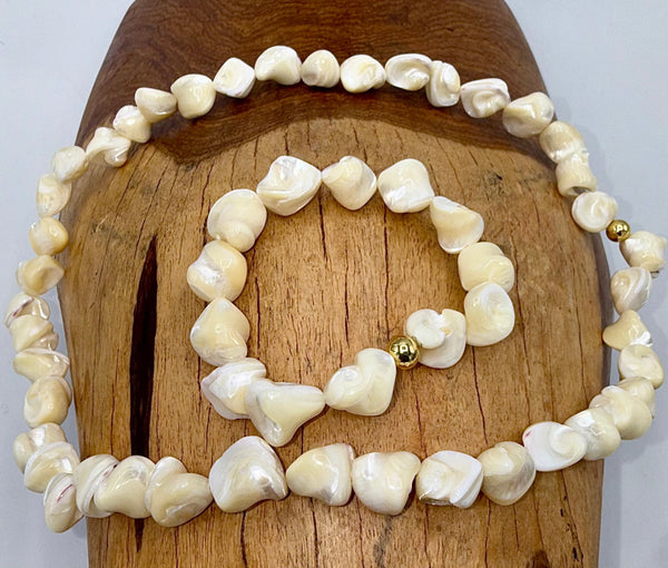 Square-shaped pearl necklace and bracelet jewelry set by STICS and STONES, featuring elegant pearl pieces on a white background.