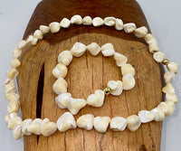 Square-shaped pearl jewelry set including necklace and bracelet by STICS and STONES, featuring elegant pearl designs.