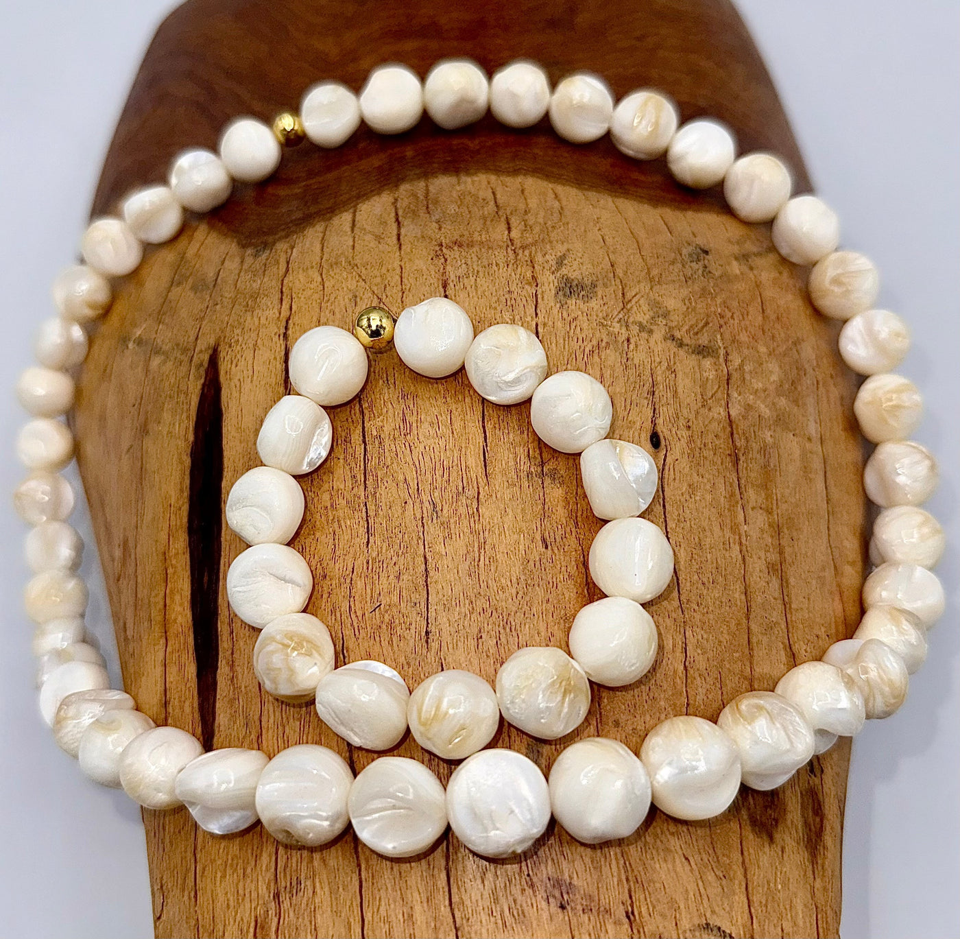 Shell-shaped pearl jewelry set including necklace and bracelet from STICS and STONES, featuring lustrous pearls and elegant design.