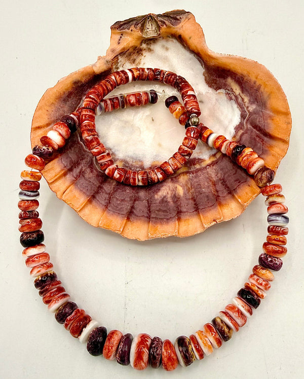 Spiny oyster jewelry set featuring matching necklace and bracelet from STICS and STONES with vibrant orange and red stones.