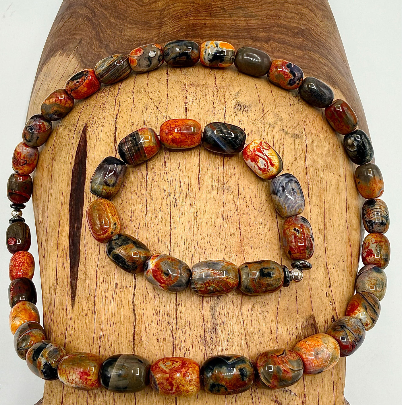 Black, red, and orange agate jewelry set featuring a necklace and bracelet from STICS and STONES.