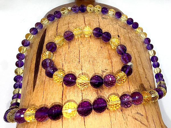 Faceted amethyst and citrine jewelry set with necklace and bracelet, featuring dark purple and orange gemstones from STICS and STONES.