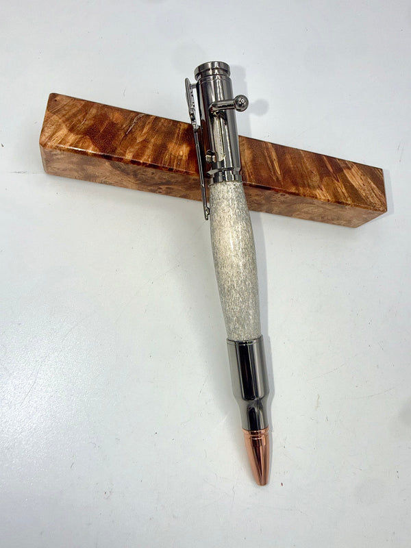 Hand-turned deer antler bullet pen by STICS and STONES with a polished wood finish and metal clip.