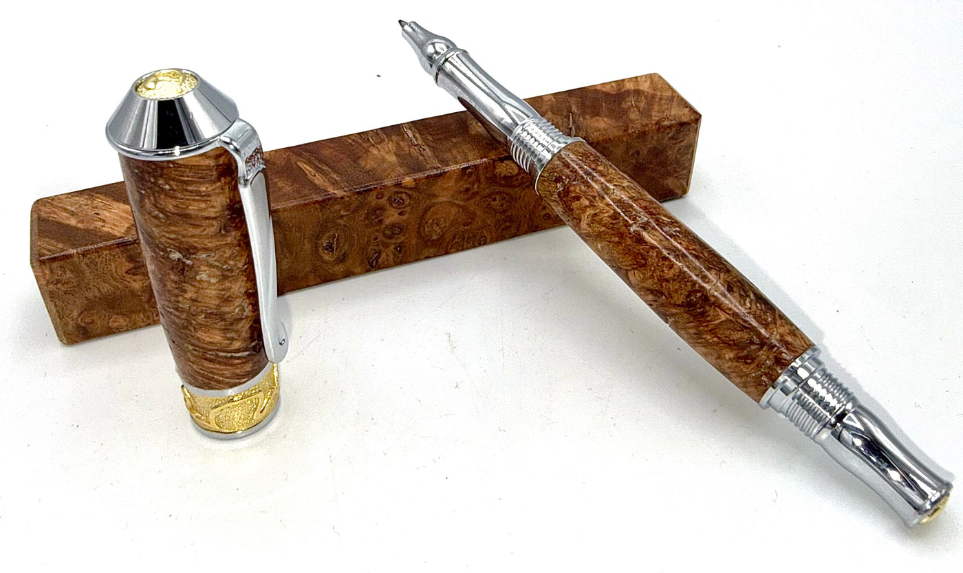 Hand-turned black ash burl wood pen by STICS and STONES showcasing smooth, polished wood with a sleek pen tip.