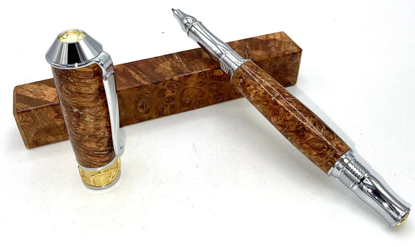 Hand-turned black ash burl wood pen by STICS and STONES showcasing smooth, polished wood with a sleek pen tip.