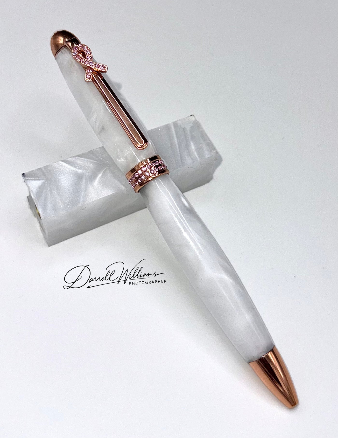 Hand-turned white acrylic and crystal breast cancer awareness pen by STICS and STONES with elegant design and branding.
