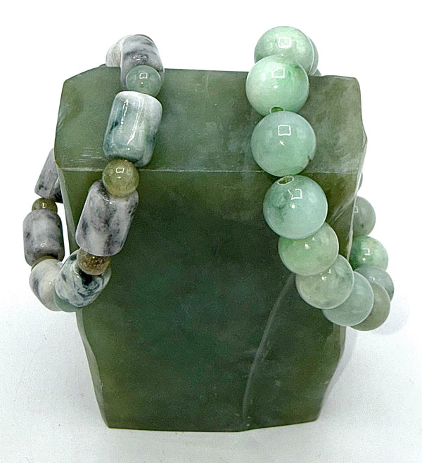 Close-up of a Jade bracelet by STICS and STONES featuring smooth green jade beads on a stretchy cord.