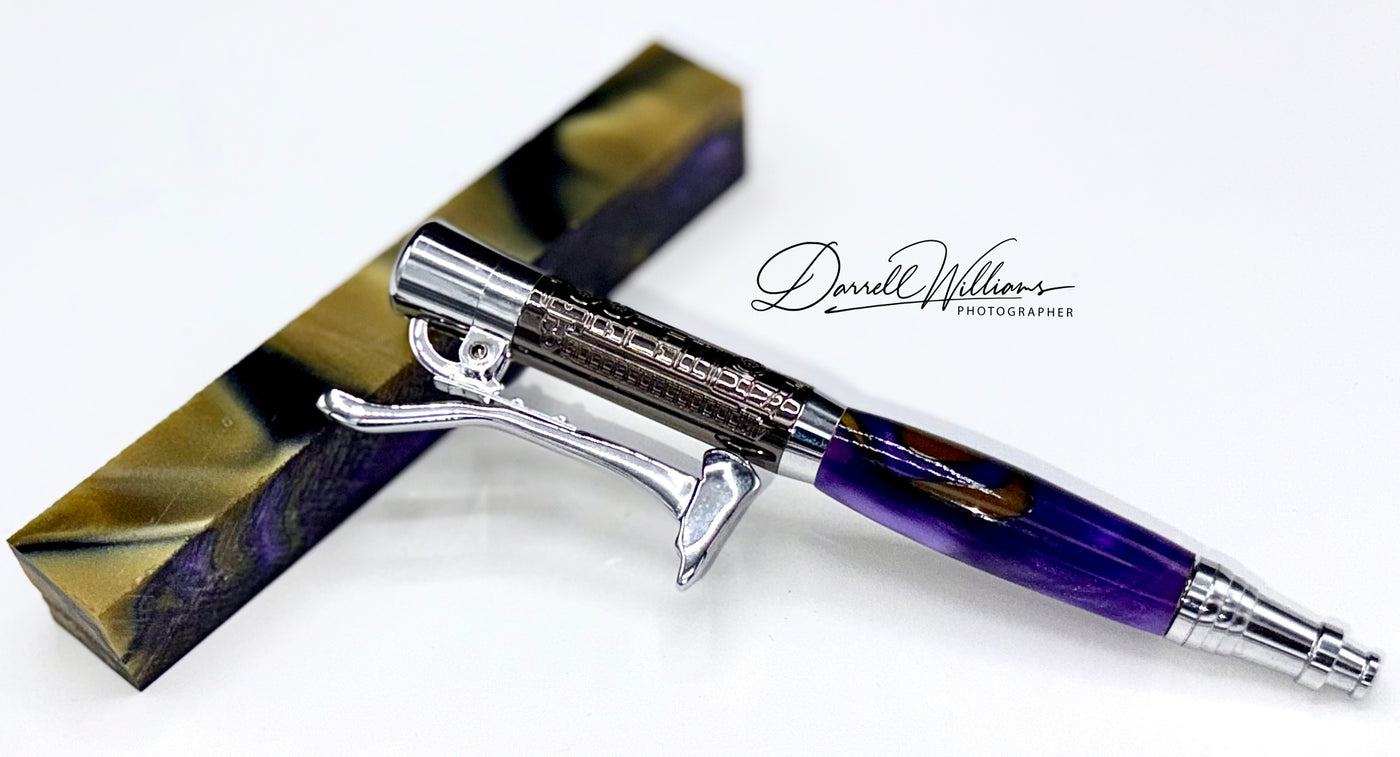 Hand-turned Royal Purple and gold acrylic pen by STICS and STONES, showcasing a smooth, glossy finish and elegant design.