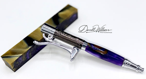 Hand-turned Royal Purple and gold acrylic pen by STICS and STONES, showcasing a smooth, glossy finish and elegant design.